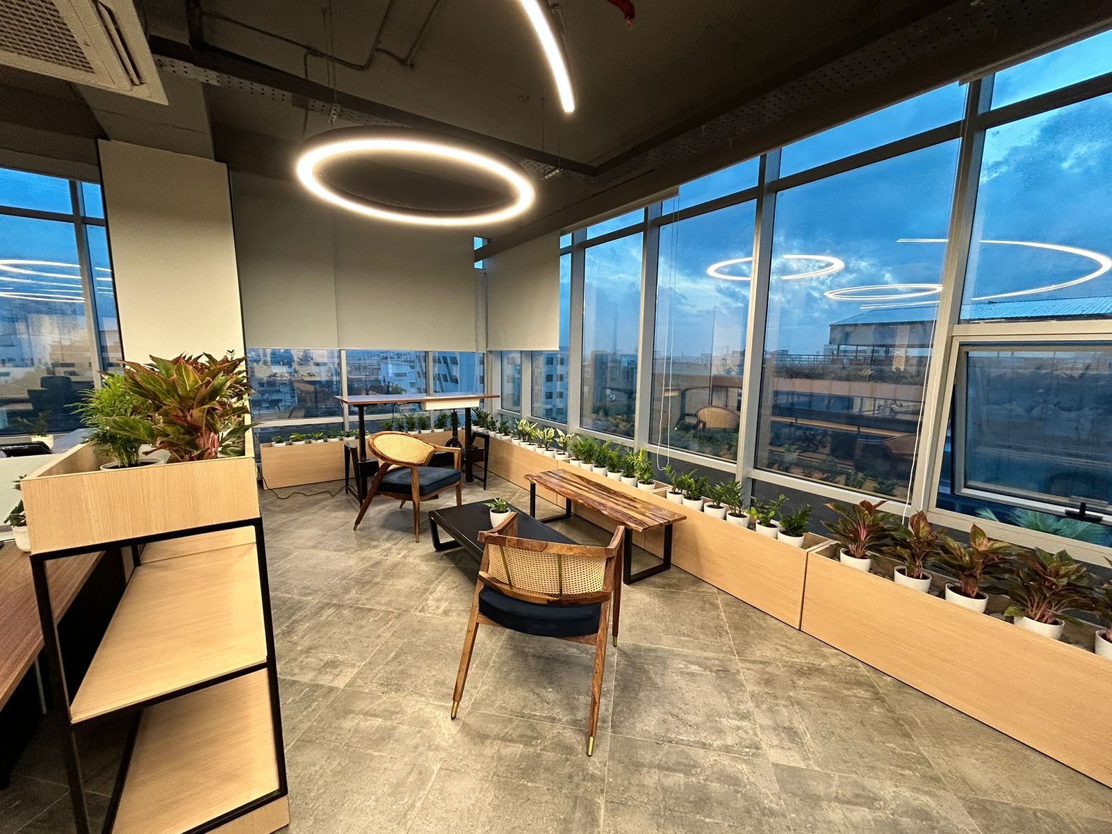 Ringfeder open lounge with floor-to-ceiling windows overlooking the city at dusk